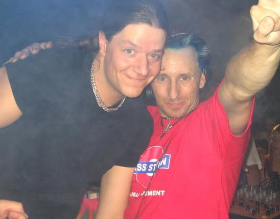Old photograph of Jason Midro with blue hair and a friend, both in Bass Station shirts