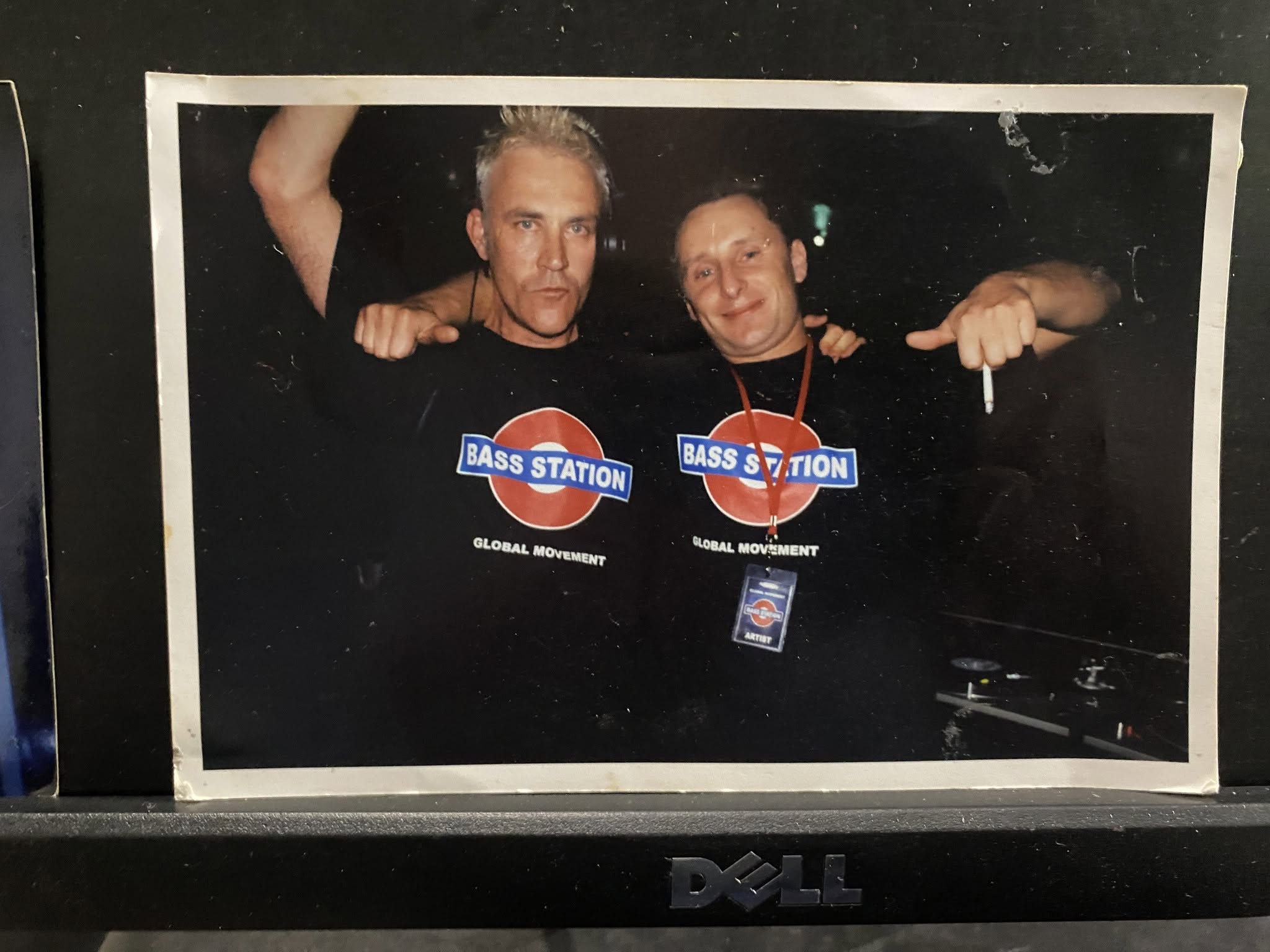 Old photograph of Jason Midro with a fellow DJ, both wearing Bass Station Global Movement t-shirts