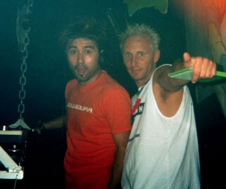 Two friends, one in a white Bass Station tank top, at a club night